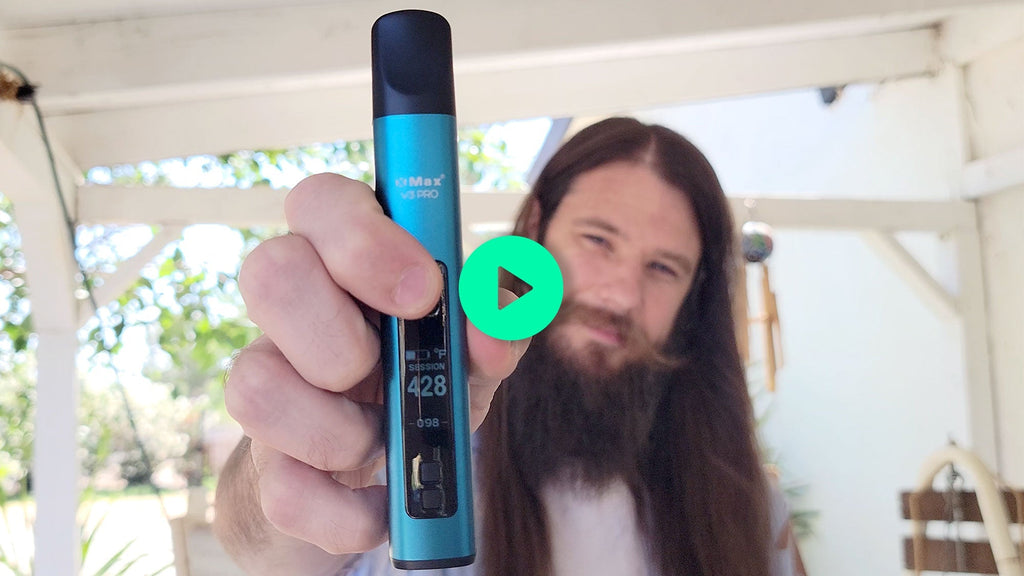 person holding xmax v3 pro herbal vaporizer