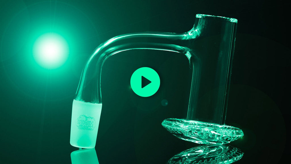 glass dab rig glowing with a green light on background
