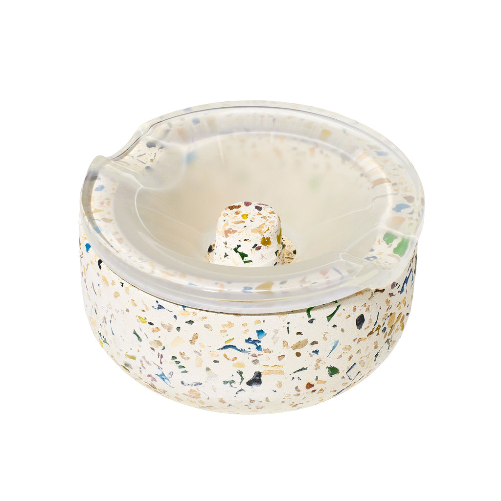 Round terrazzo ashtray with a clear lid on a white background