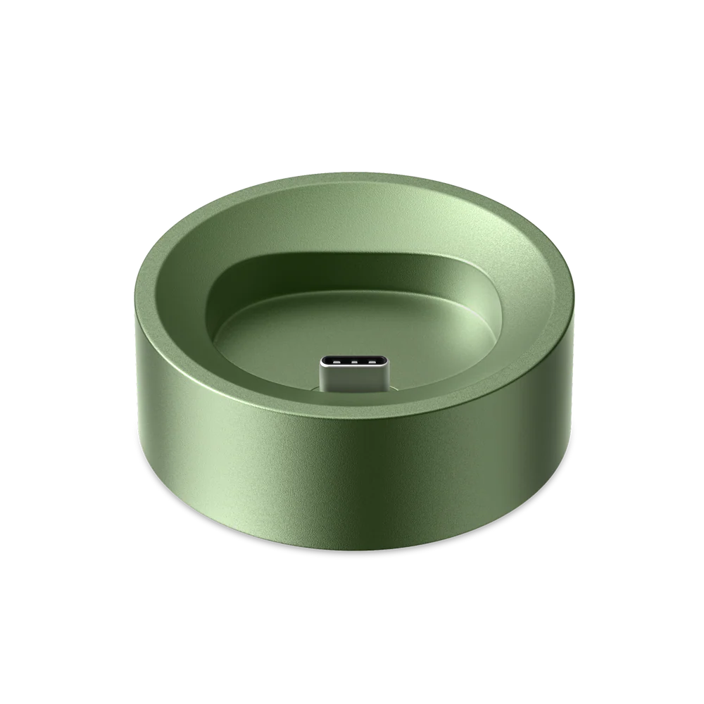Green circular Pax Flow charging dock on a white background